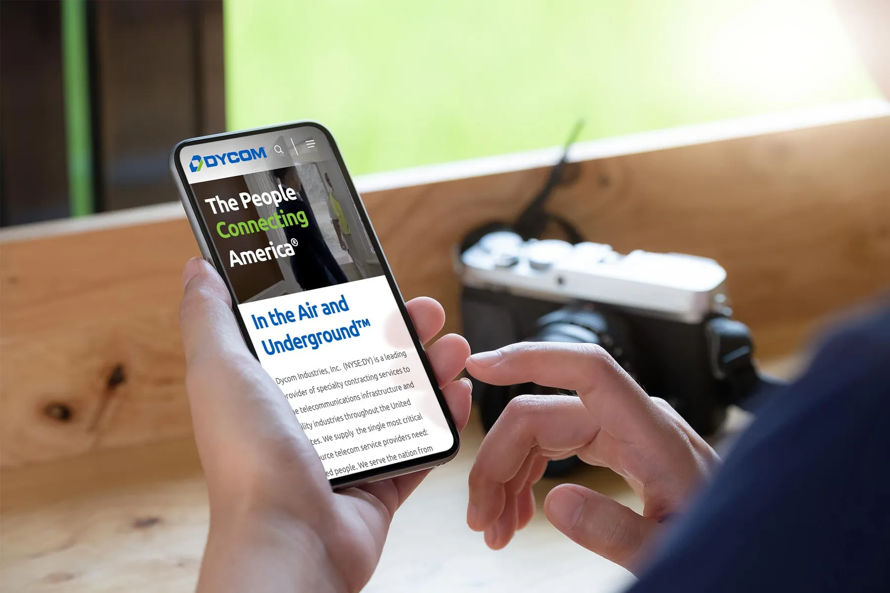 Redesigned Dycom homepage on a phone, showing the headline and the In the Air and Underground introduction